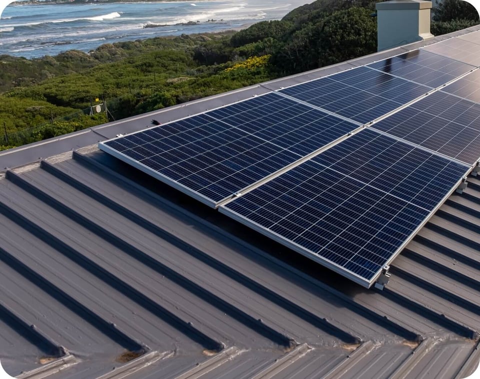 Solar panels installed on a waterfront home's metal roof