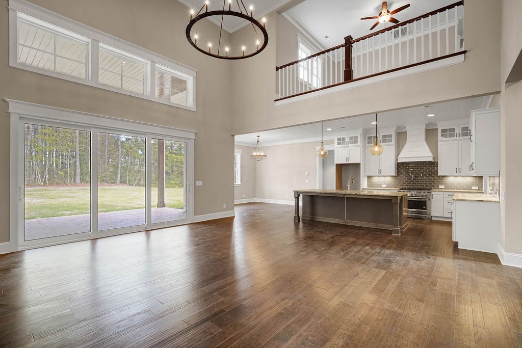 Finished custom home that is empty showing the family room connecting to the kitchen